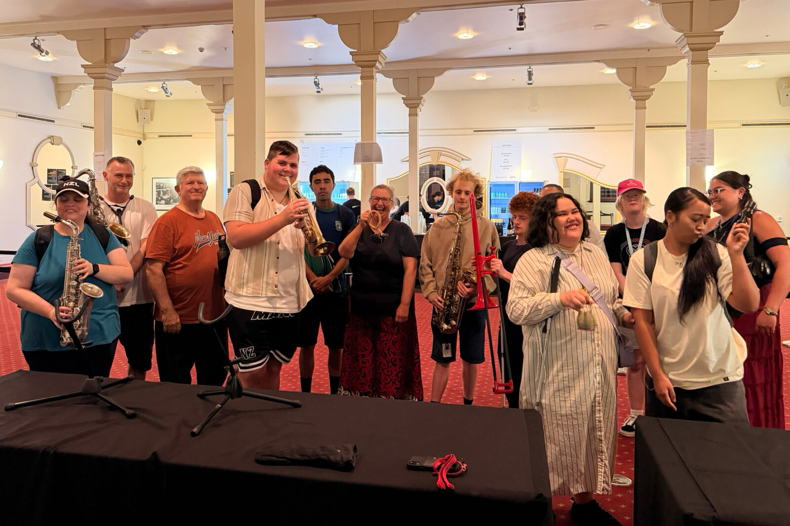A group of people explore musical instruments during an accessible pre-show touch tour.